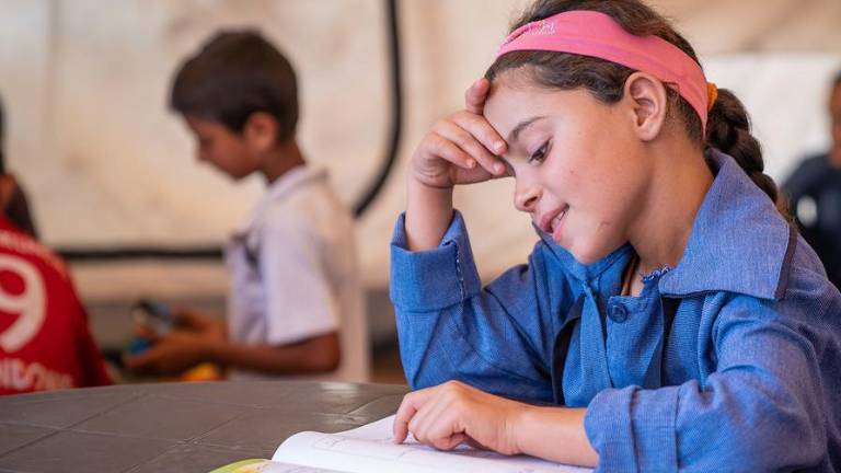 Una niña refugiada siria estudia en Jordania en un centro apoyado por UNICEF.