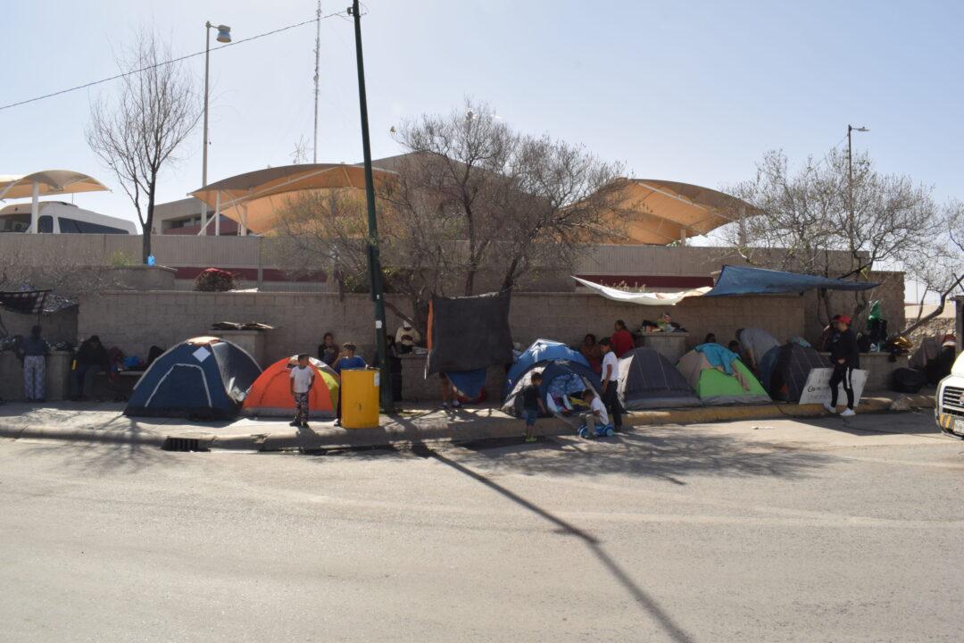 $!Migrantes extranjeros se mantienen sobre la calle Rivas Guillén, frente a la estación migratoria.