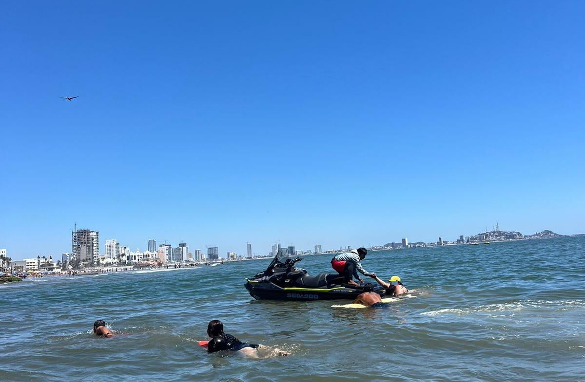 $!Cae al mar una pareja que viajaba en parachute; rescatan a 10 más que eran jalados por la resaca