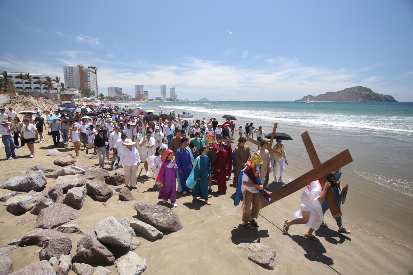 $!Decenas de personas acompañaron el viacrucis viviente que transformó la playa en un escenario de profunda espiritualidad.