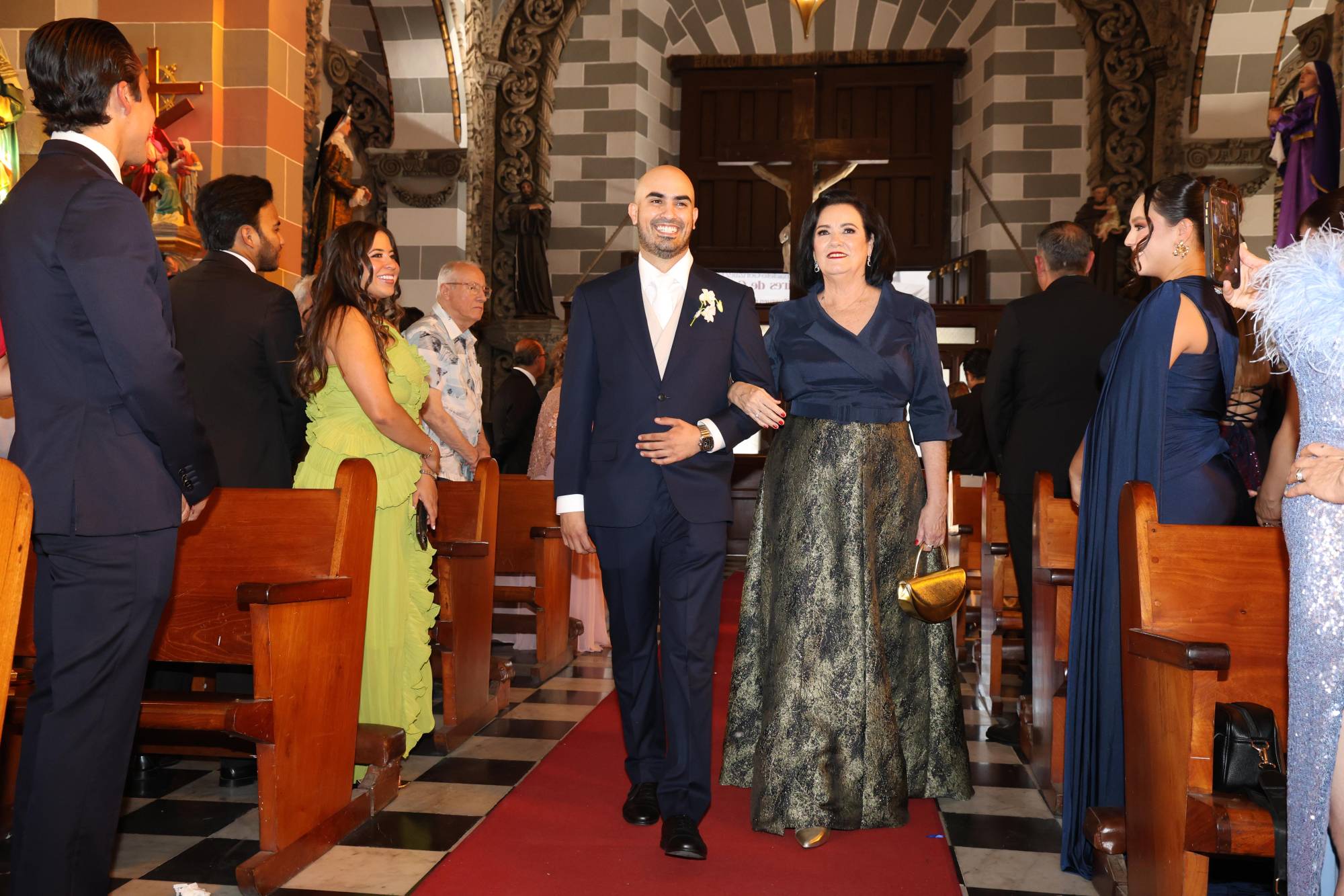 $!El novio hace su entrada del brazo de su mamá, Dora Irma Cárdenas Liñán, en un emotivo momento rumbo al altar.