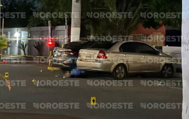 El cuerpo del hombre asesinado a balazos quedó entre dos vehículos estacionados frente a la plaza comercial.