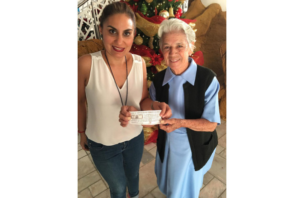 La afortunada, Chiquis Cavazos de Jiménez, muestra el boleto con la Madre Velia Morales.