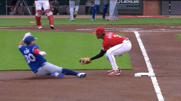 Alejandro Kirk busca alcanzar la tercera base, en el encuentro que los Azulejos le ganaron a los Rojos.