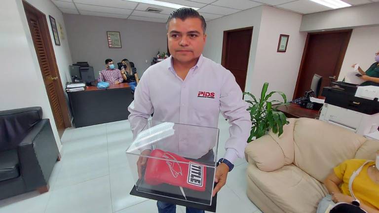 David Eduardo Vargas Rodríguez, presidente del Consejo Directivo del PIDS, muestra el guante de “El Canelo”.