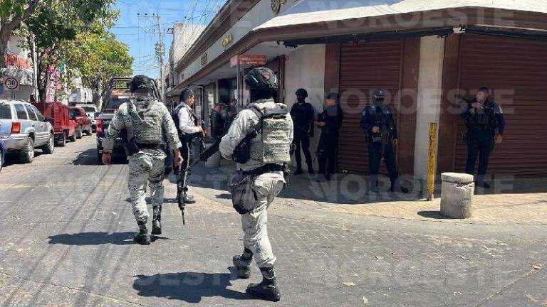 Peritos de la Fiscalía estatal realizan el levantamiento de indicios tras el ataque en la joyería.