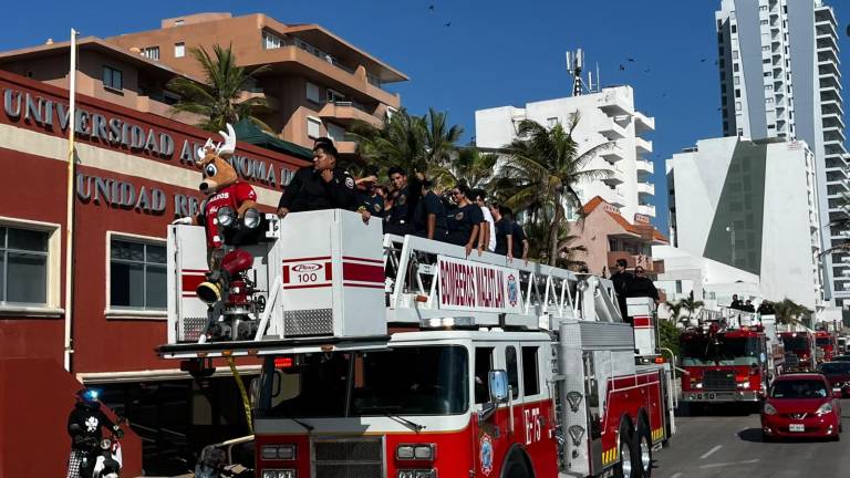 Unidades de Bomberos Voluntarios Mazatlán recorren el Malecón durante el desfile por el Día del Bombero.