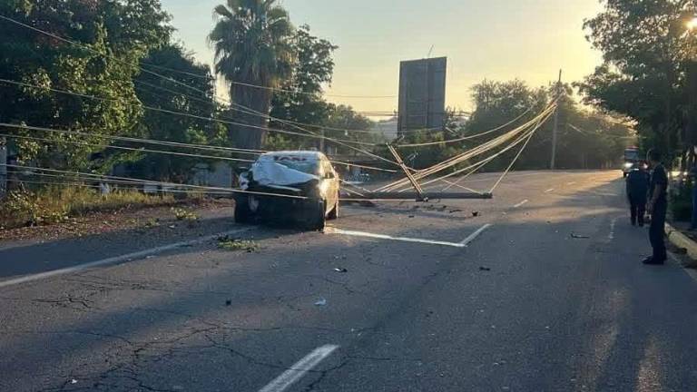 El taxi accidentado quedó junto a postes y cables de la CFE tras el fatal percance en Bariometo.
