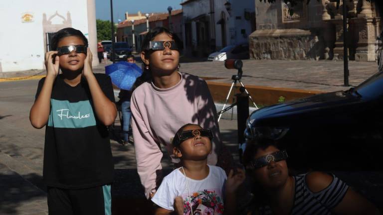 Con lentes especiales, niños y adultos observan el eclipse en la plazuela Morelos, de Concordia.