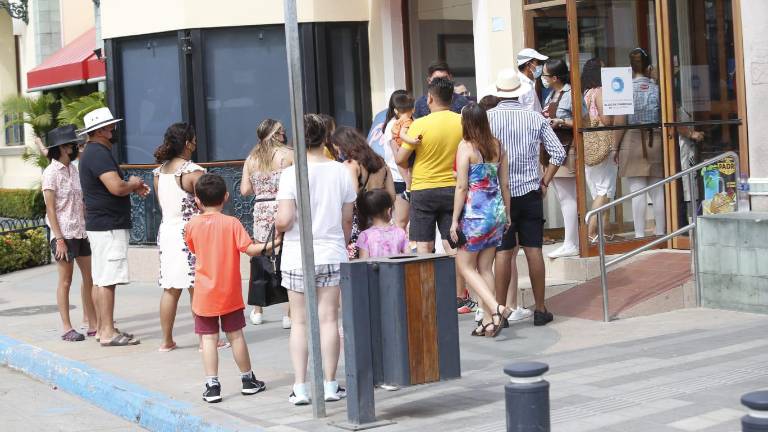 Personas a la espera de ingresar a un restaurante en la Zona Dorada.