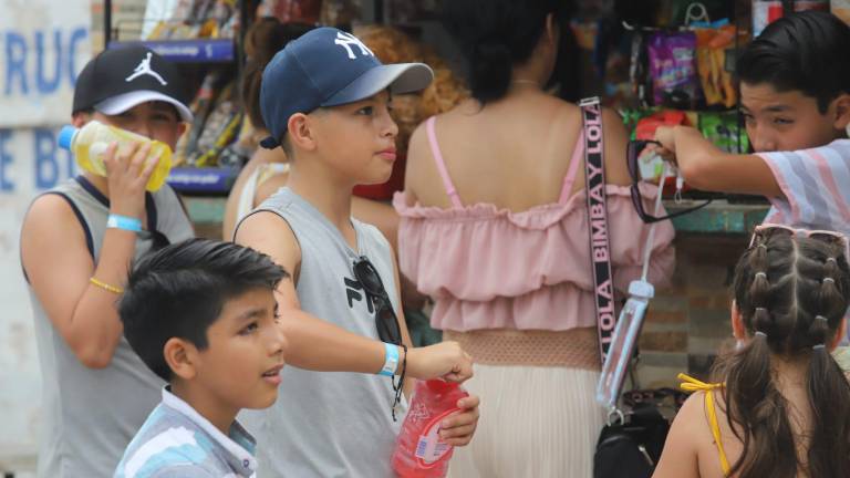 Turistas se hidratan antes de subir al Faro Mazatlán durante la mañana.