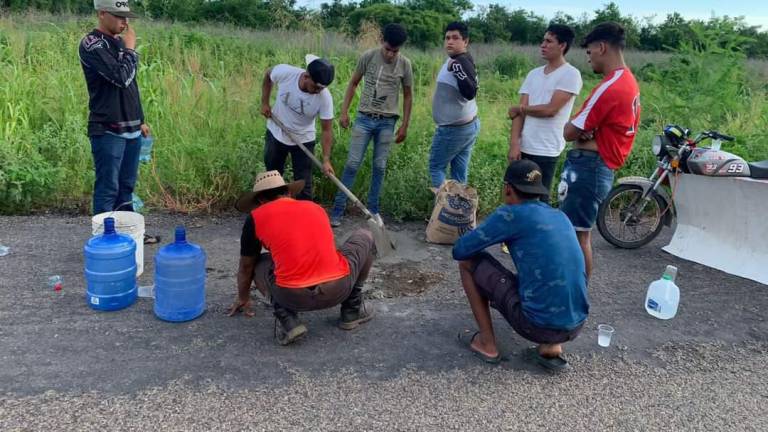 Agrupación de motociclistas repara baches y deslave de tierra en carretera de Rosario