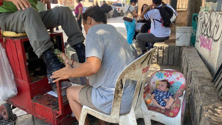 Carolina del Carmen lustra calzado en las calles de la Plazuela Obregón para buscar la manera de comprar alimento para su familia