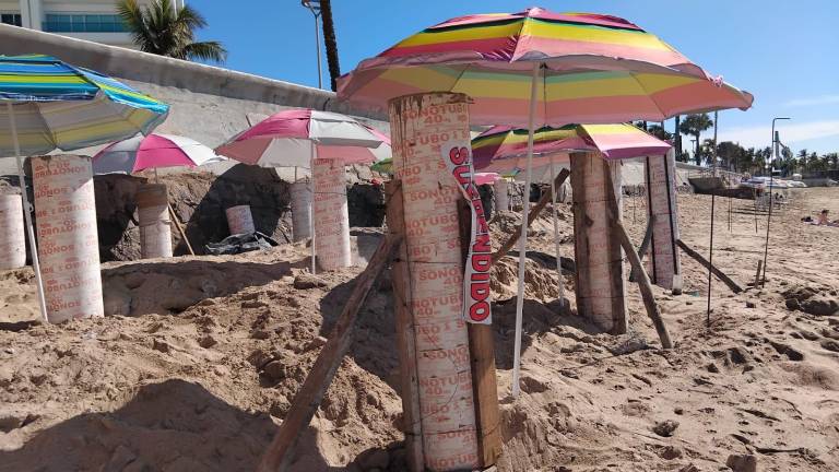 Sobre los pilotes de concreto de la obra suspendida, en la zona de playa de la Avenida del Mar, fueron colocadas sombrillas de colores.