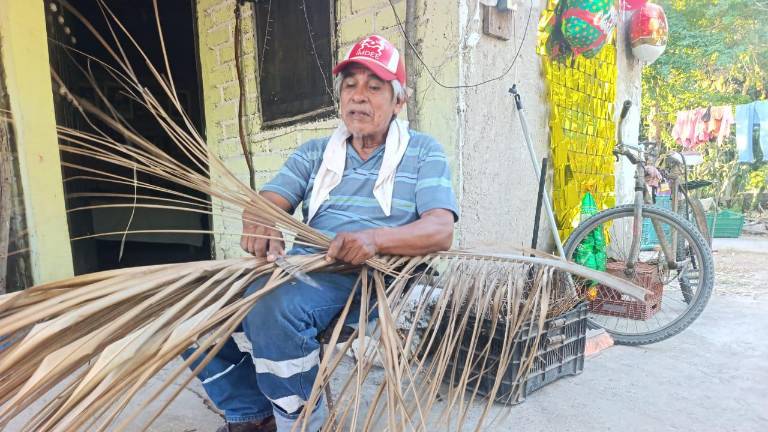 Pablo Ruiz elabora de manera artesanal escobas de palapa de coco, un oficio que aprendió de su suegro en Escuinapa.