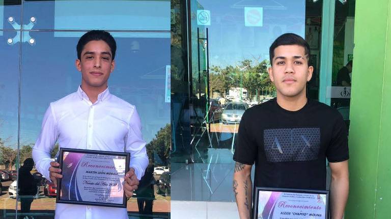 Martín León y Alexis Molina muestran sus reconocimientos.
