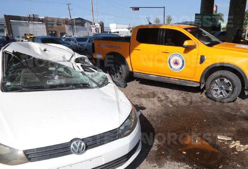 $!Camión de hielo vuelca y cae sobre auto al sur de Mazatlán; mujer resulta lesionada