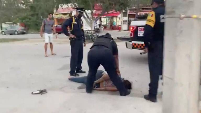 Los agentes policiacos en el momento en que someten a Victoria.