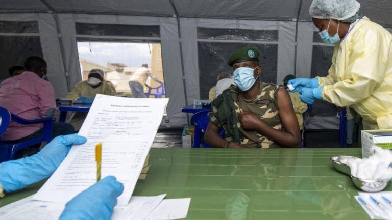 Una enfermera inyecta la primera dosis de la vacuna Covid-19 a un soldado de 45 años en la República Democrática del Congo.