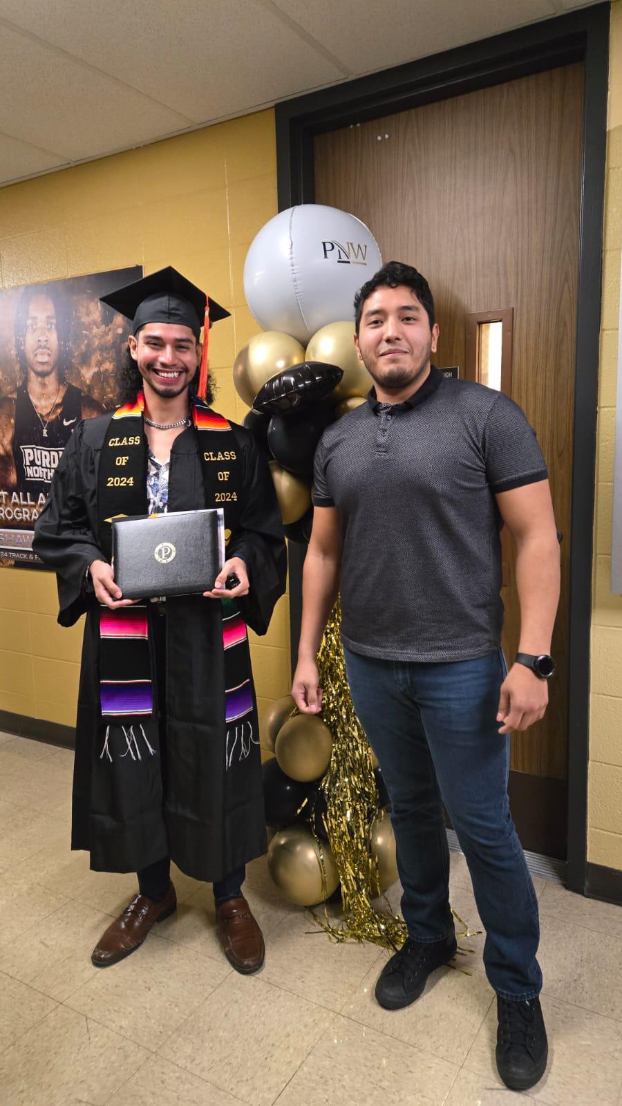 $!Eros con su documento de graduación junto a su amigo y compañero de estudio Sergio Mendieta.